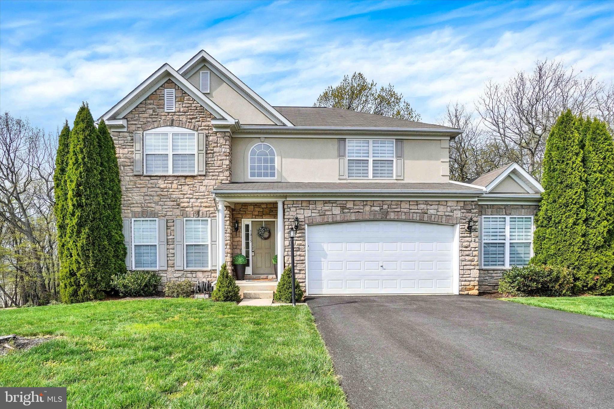 1015 Nugent Way York, PA 17402 - Photo 2 of 46 a front view of a house with a garden and garage
