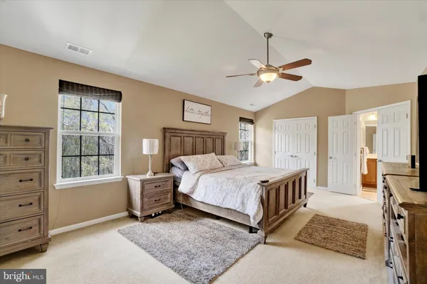 a bedroom with a bed a window and closet