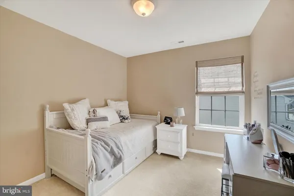 a bed room with a bed and a chair