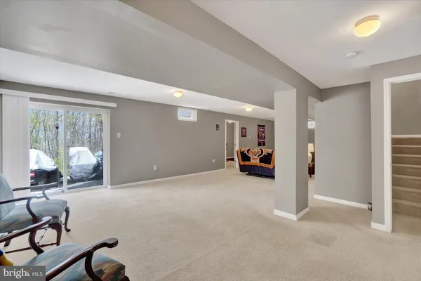 a view of a livingroom with furniture and a ceiling fan