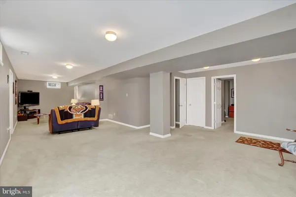 a big room with furniture and a window