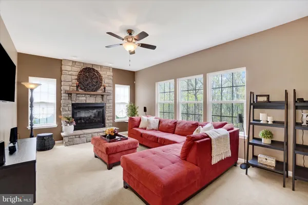 a living room with furniture a chandelier and a large window