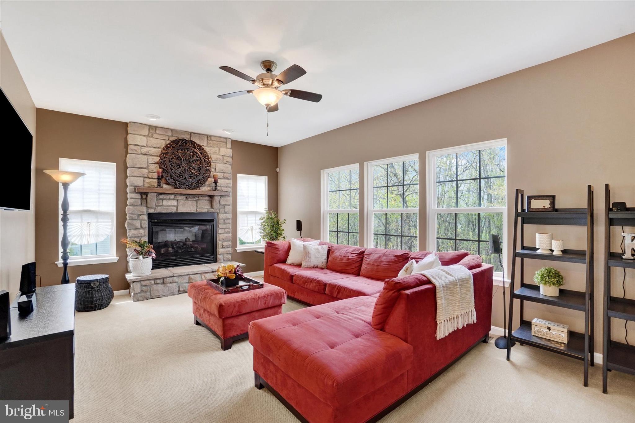 1015 Nugent Way York, PA 17402 - Photo 9 of 46 a living room with furniture a chandelier and a large window