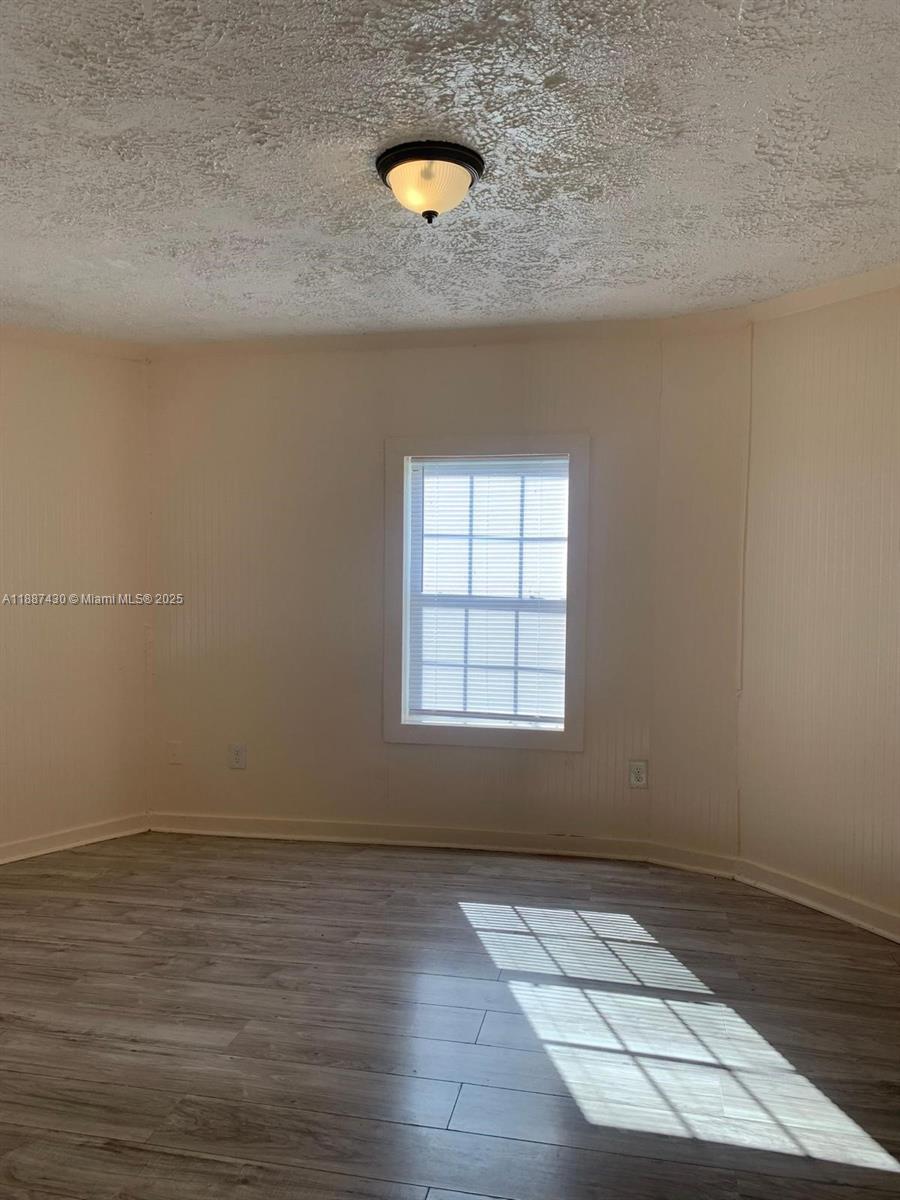 1129 Grothe Street Jacksonville, FL 32209 - Photo 11 of 21 an empty room with wooden floor and windows