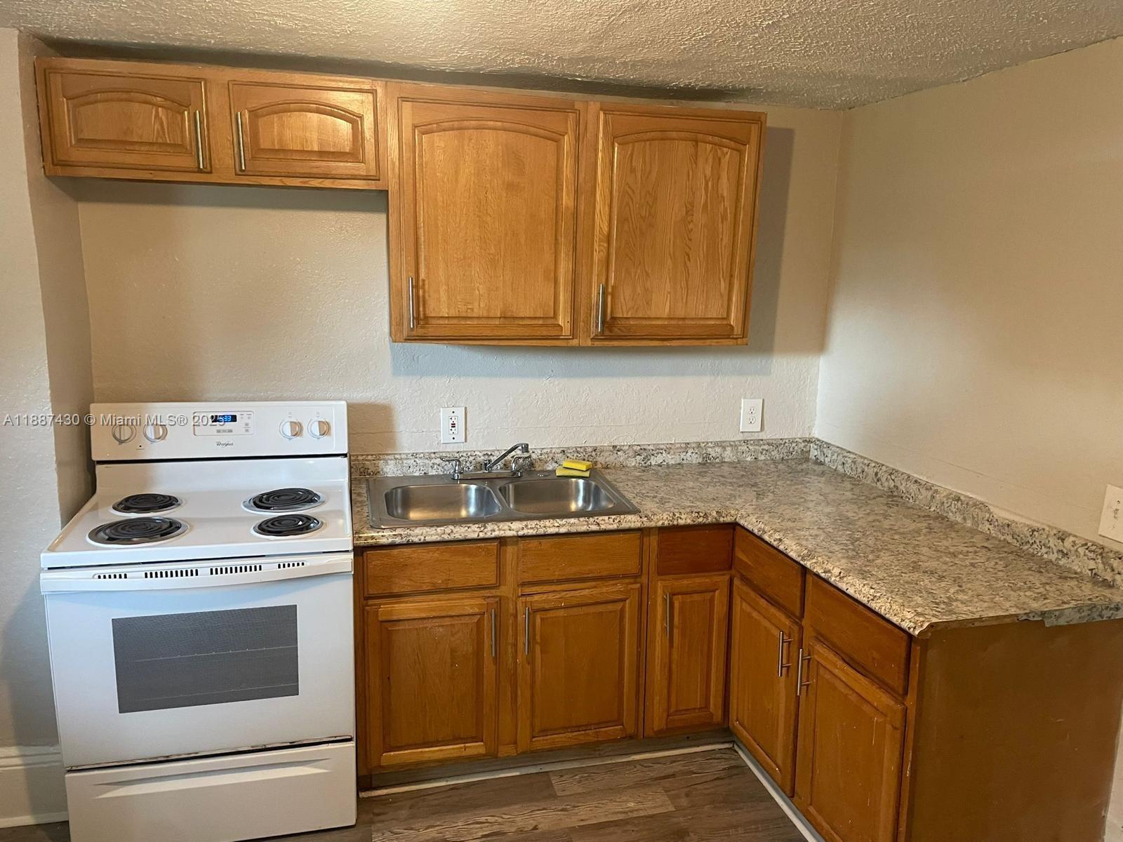 1129 Grothe Street Jacksonville, FL 32209 - Photo 5 of 21 a kitchen with a stove top oven sink and cabinets