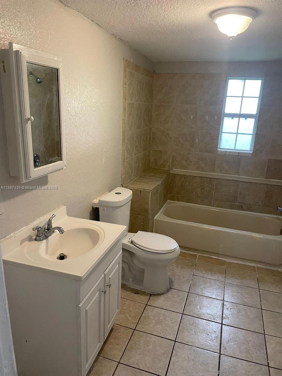 1129 Grothe Street Jacksonville, FL 32209 - Photo 8 of 21 a bathroom with a sink a toilet and mirror
