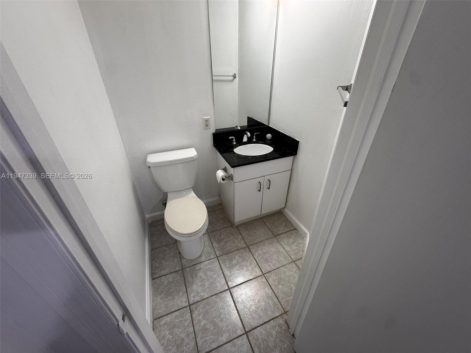 701 Brickell Key Boulevard, Unit 1208 Miami, FL 33131 - Photo 13 of 14 a bathroom with a toilet and a sink