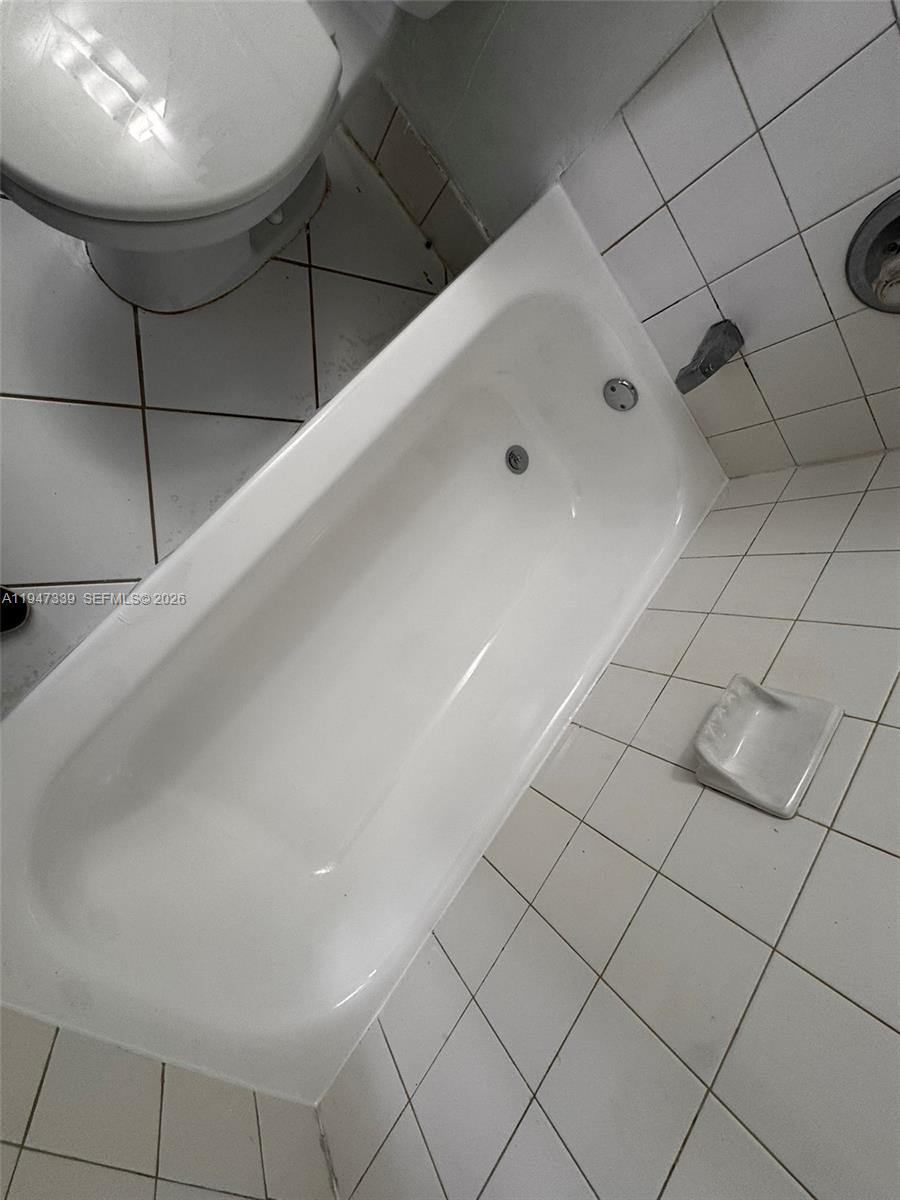 701 Brickell Key Boulevard, Unit 1208 Miami, FL 33131 - Photo 6 of 14 a bathroom with a bathtub and shower