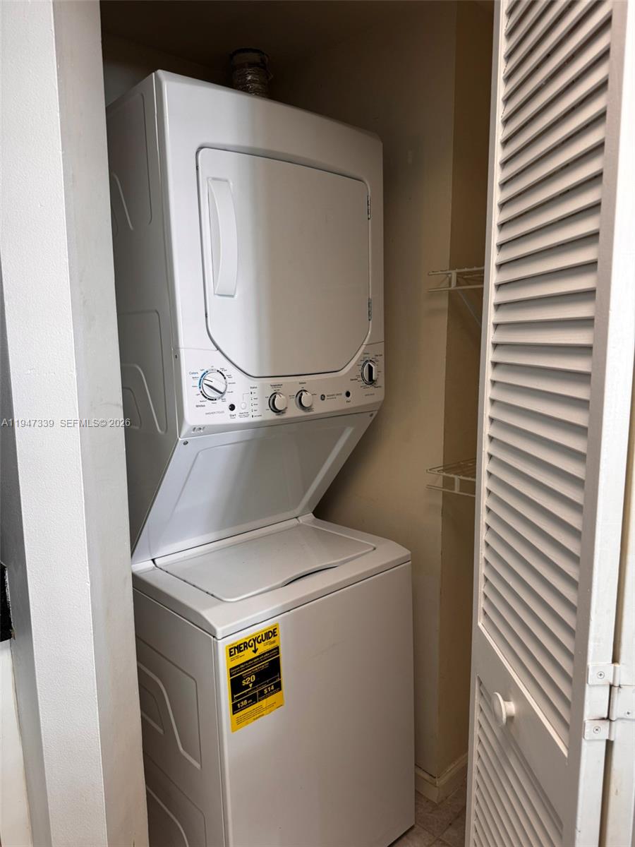 701 Brickell Key Boulevard, Unit 1208 Miami, FL 33131 - Photo 10 of 14 a utility room with dryer and washer