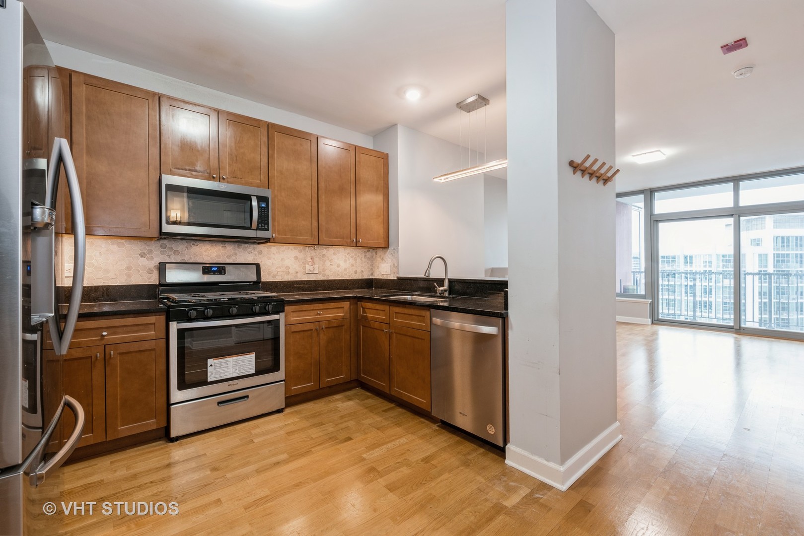 1600 South Prairie Avenue, Unit 2005 Chicago, IL 60616 - Photo 2 of 12 a kitchen with granite countertop a stove top oven and sink