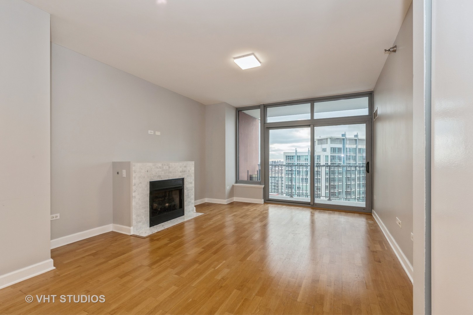 1600 South Prairie Avenue, Unit 2005 Chicago, IL 60616 - Photo 4 of 12 a view of an empty room with wooden floor and a window
