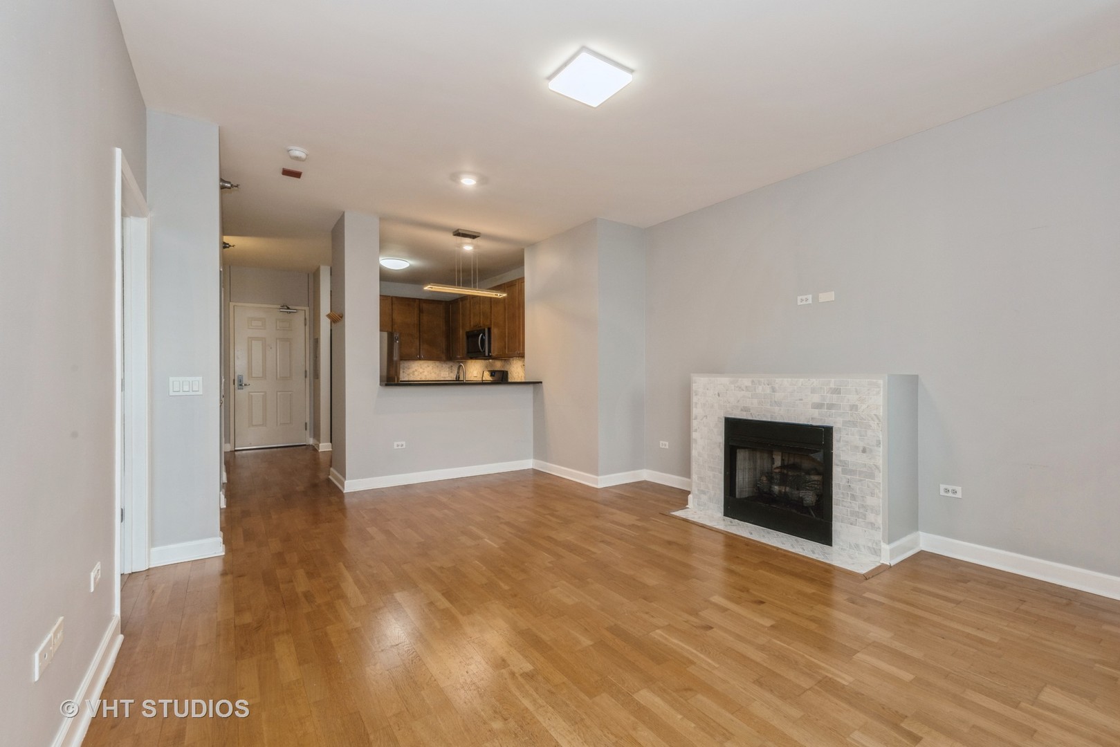 1600 South Prairie Avenue, Unit 2005 Chicago, IL 60616 - Photo 5 of 12 a view of an empty room and a kitchen with a sink