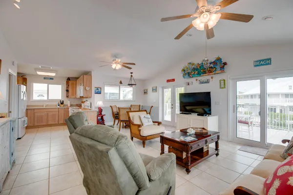 a kitchen with a sink window and white cabinets