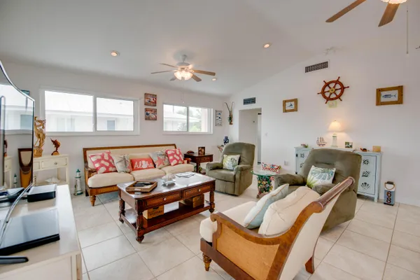 a bedroom with a bed ceiling fan and a window