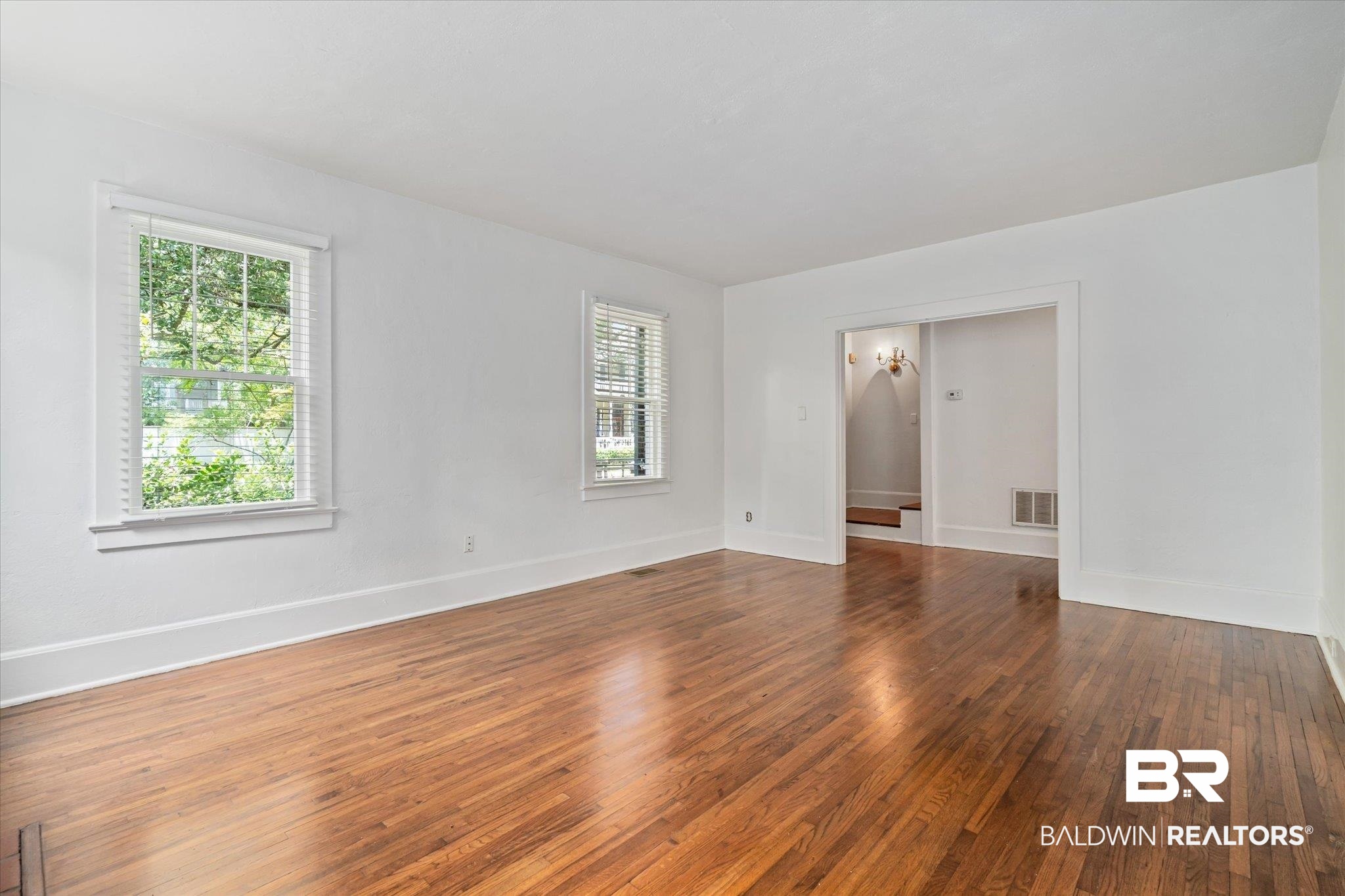 1159 Palmetto Street Mobile, AL 36604 - Photo 4 of 21 Empty room with a healthy amount of sunlight and hardwood / wood-style floors