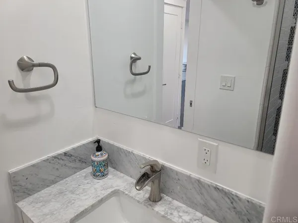 a bathroom with a granite countertop sink