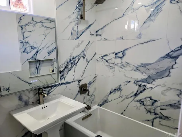 a bathroom with a sink a toilet and a mirror