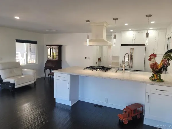 a kitchen with sink refrigerator and window