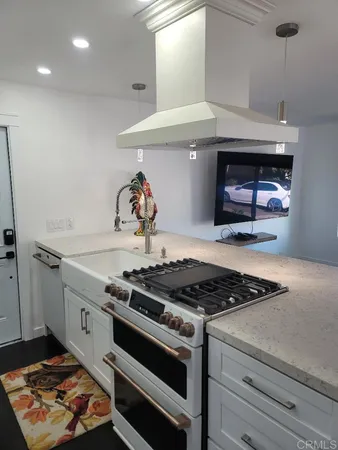 a stove top oven sitting inside of a kitchen
