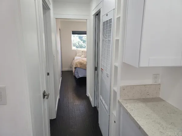 a view of hallway with wooden floor