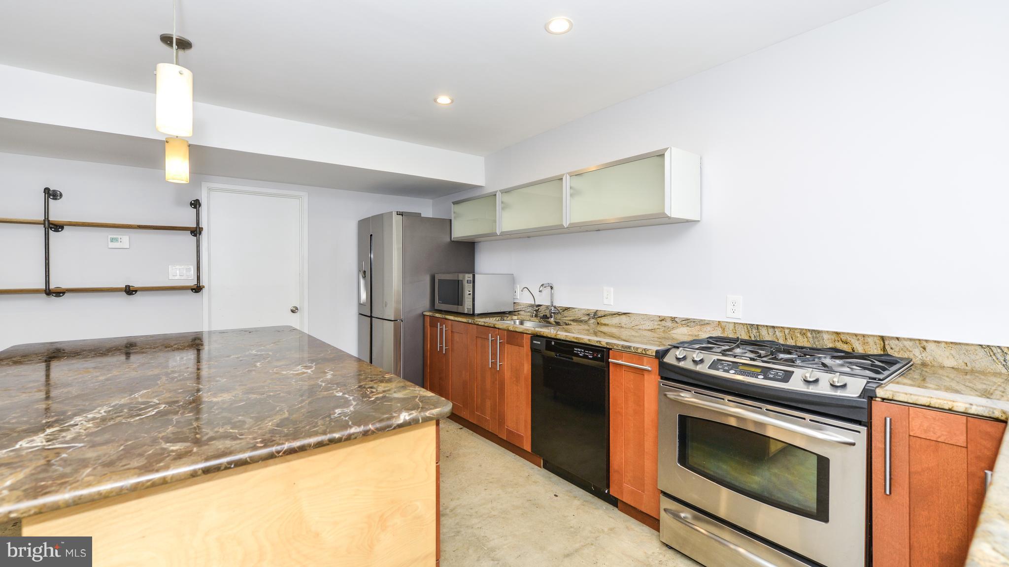 11533 Hickory Cluster Reston, VA 20190 - Photo 2 of 30 a kitchen with stainless steel appliances granite countertop a stove a sink and a microwave