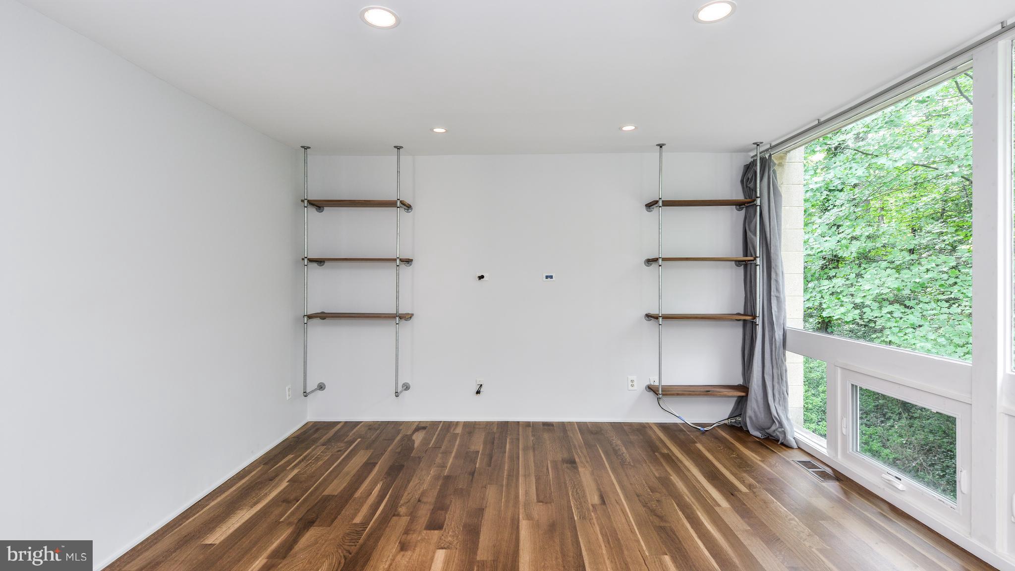 11533 Hickory Cluster Reston, VA 20190 - Photo 16 of 30 an empty room with wooden floor and windows