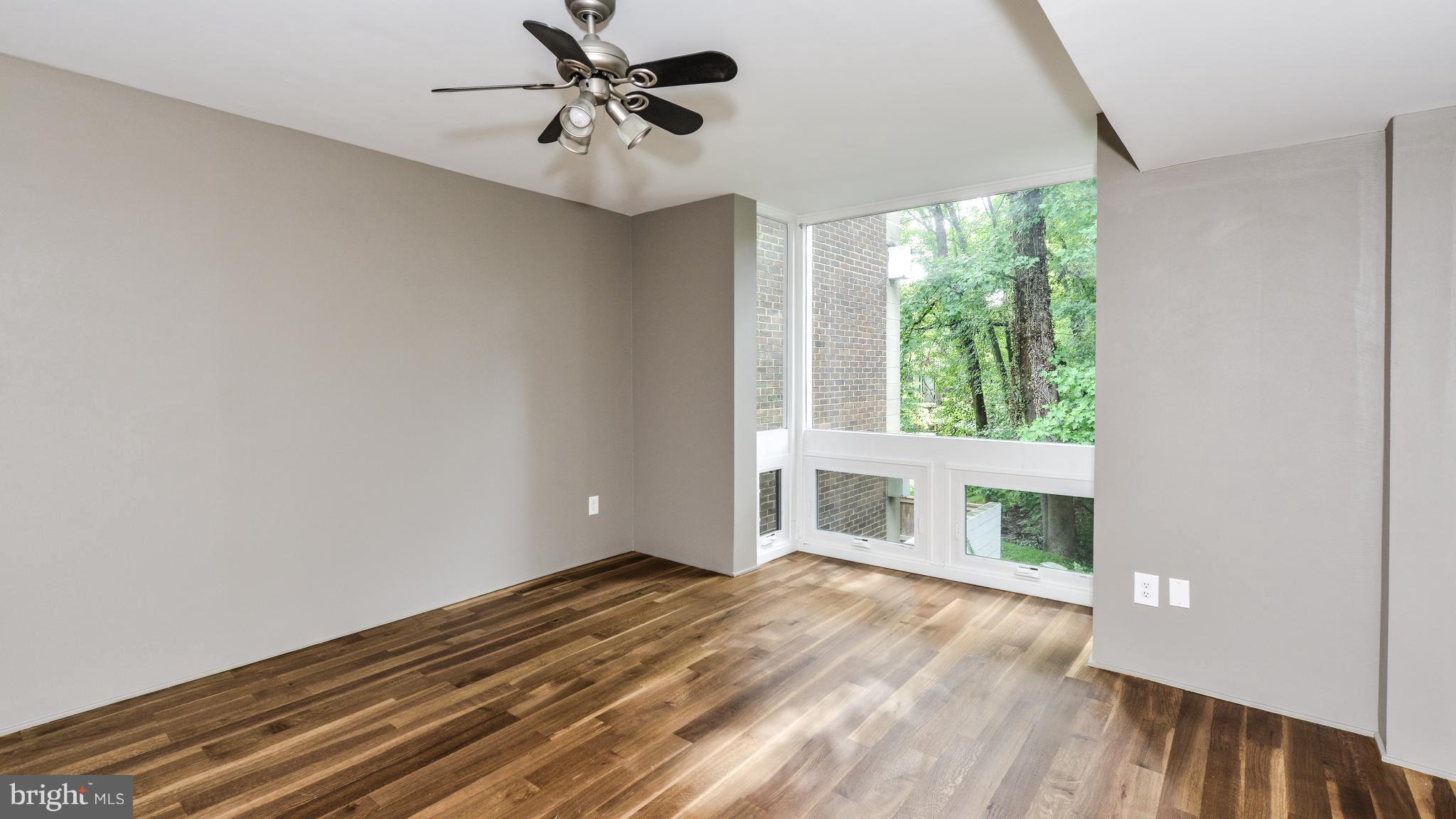 11533 Hickory Cluster Reston, VA 20190 - Photo 17 of 30 a view of empty room with wooden floor and fan