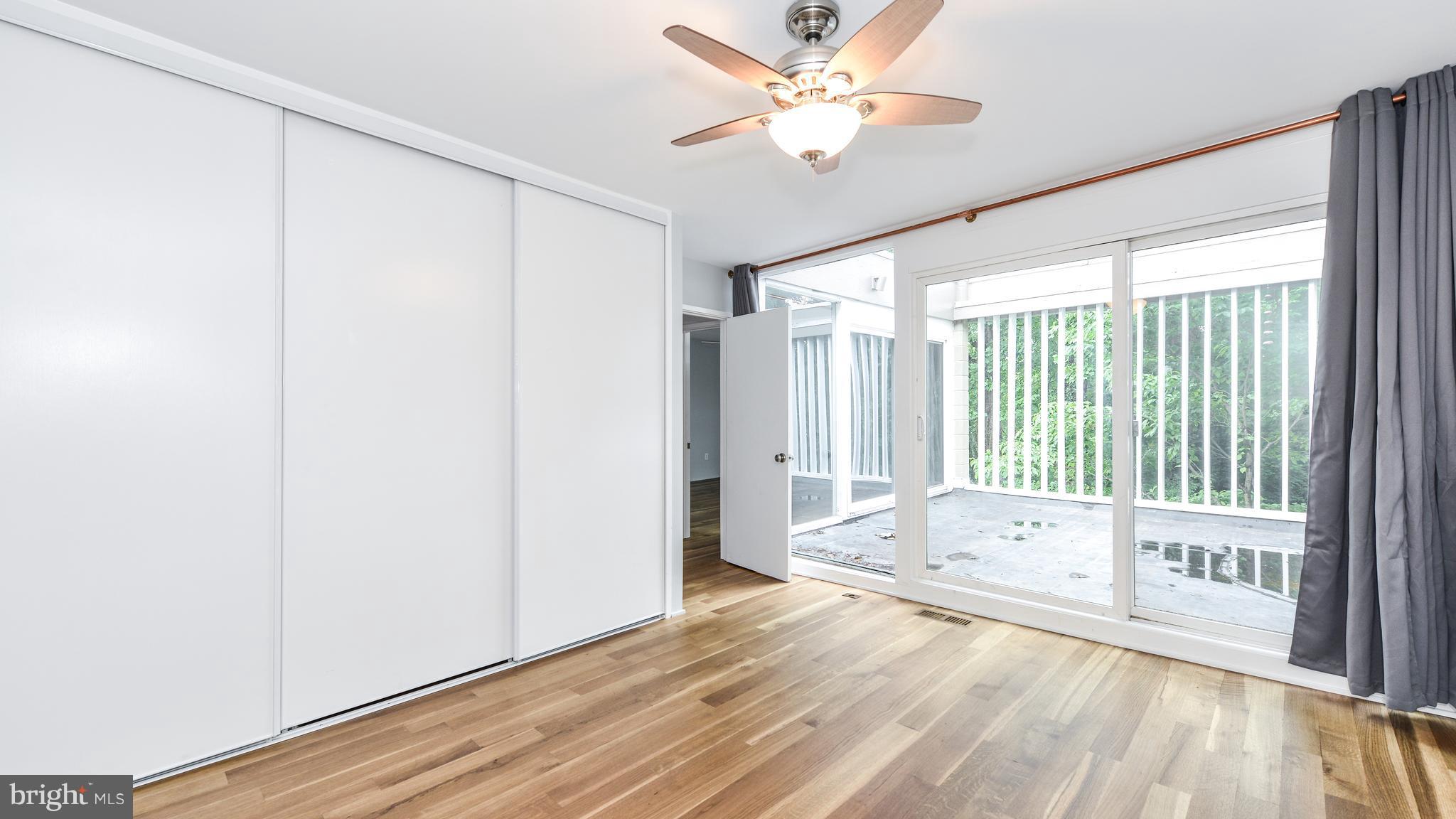 11533 Hickory Cluster Reston, VA 20190 - Photo 21 of 30 a view of an empty room with a window and wooden floor