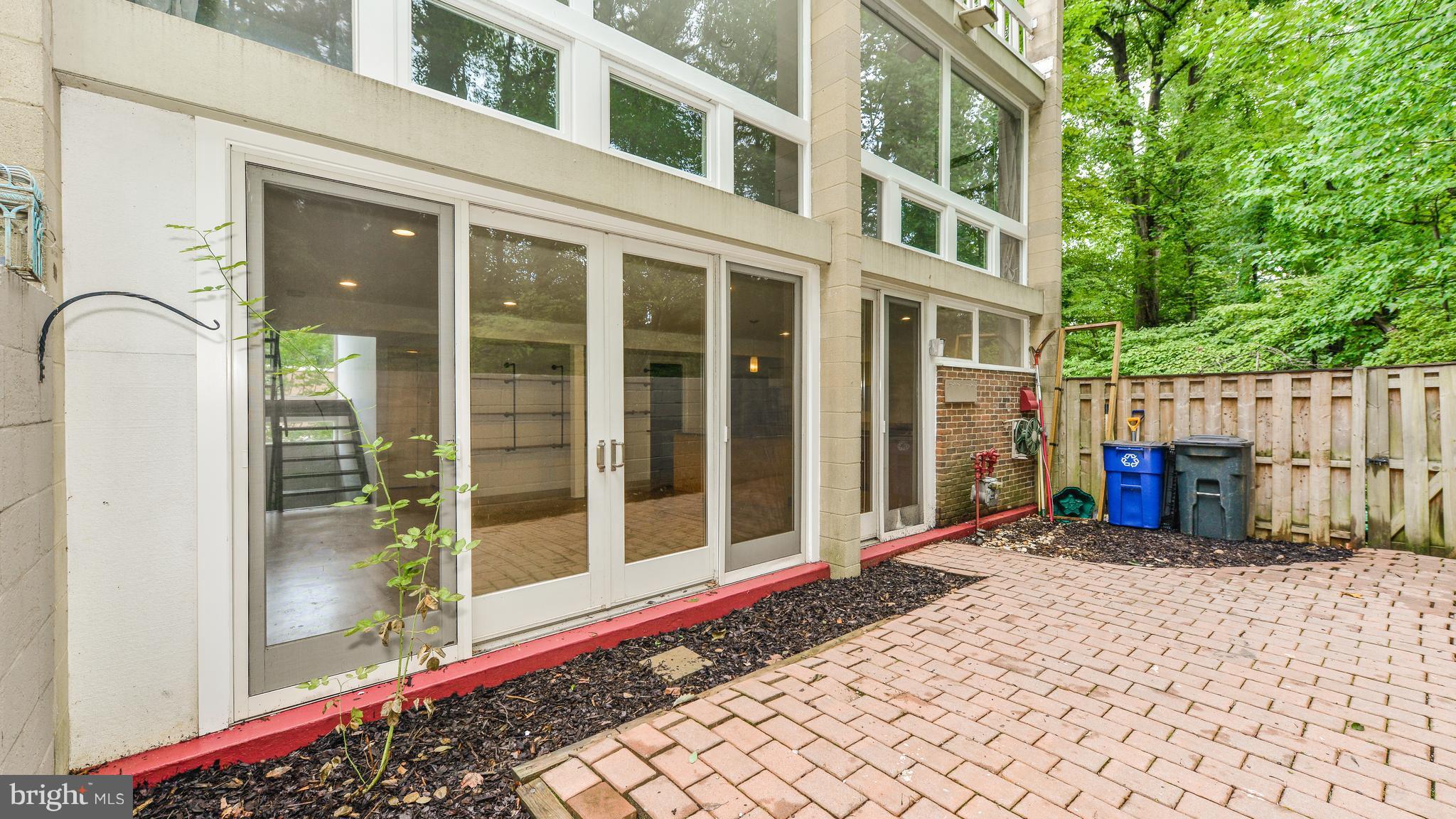 11533 Hickory Cluster Reston, VA 20190 - Photo 28 of 30 a view of a building with a bench in front of house