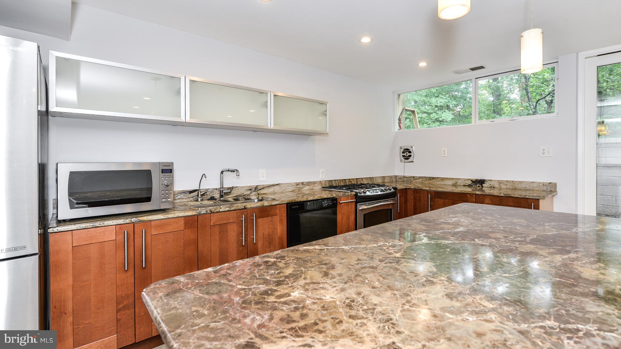 11533 Hickory Cluster Reston, VA 20190 - Photo 5 of 30 a kitchen with stainless steel appliances granite countertop a sink and a stove