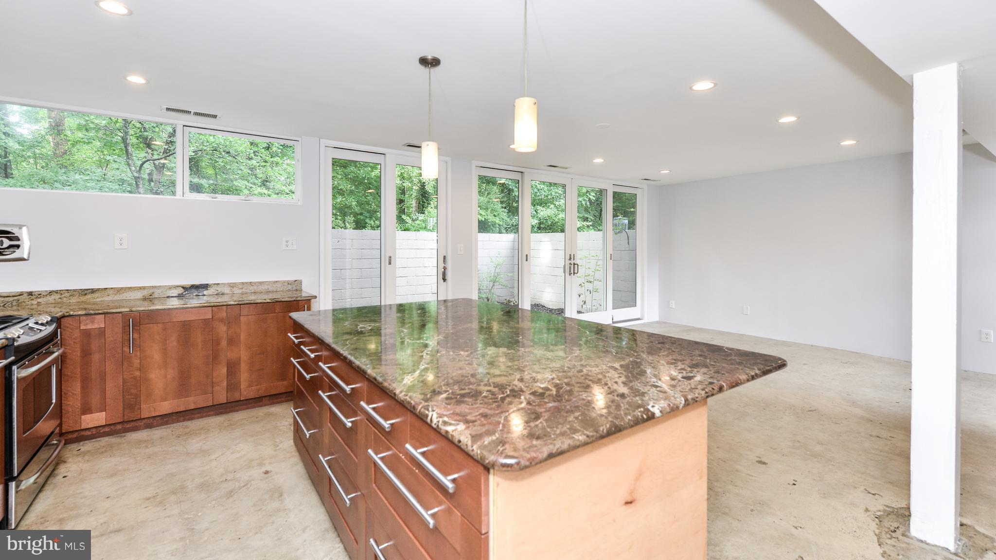 11533 Hickory Cluster Reston, VA 20190 - Photo 7 of 30 a kitchen with kitchen island a large window in it