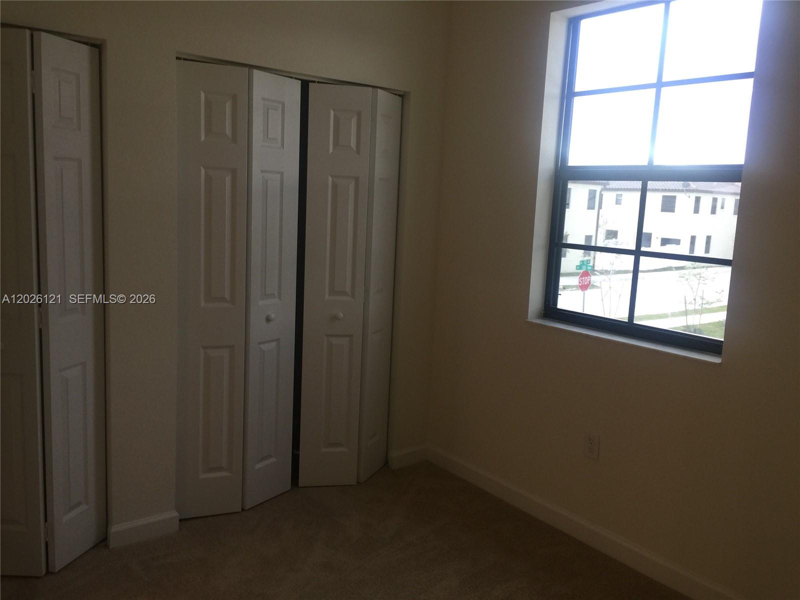 9307 West 33rd Way Hialeah, FL 33018 - Photo 14 of 23 an empty room with windows