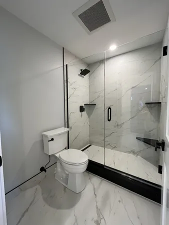 a bathroom with a toilet and a shower