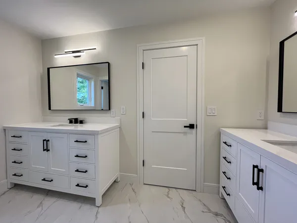a bathroom with a sink a mirror and a bathtub