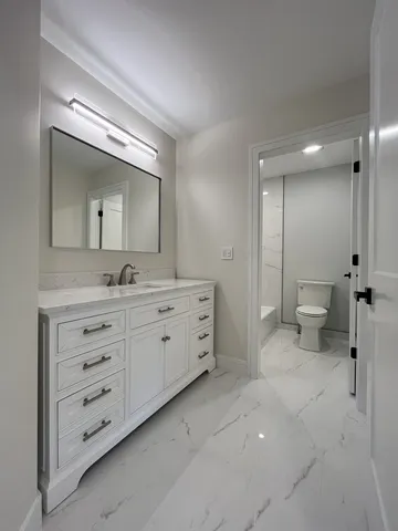 a bathroom with a double vanity sink and mirror