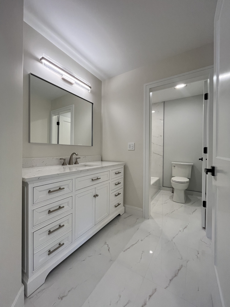 416 South 12th Avenue St. Charles, IL 60174 - Photo 10 of 20 a bathroom with a double vanity sink and mirror