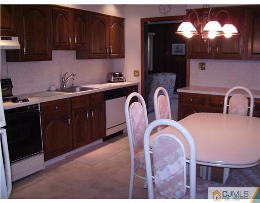 14 Cambridge Road Edison, NJ 08817 - Photo 3 of 10 a kitchen with stainless steel appliances granite countertop a sink a microwave and cabinets