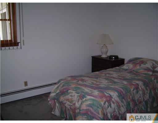 14 Cambridge Road Edison, NJ 08817 - Photo 8 of 10 a bedroom with a bed and a window