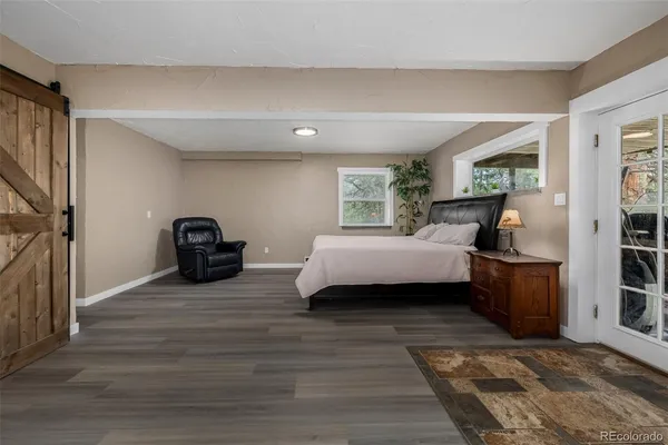 a bedroom with furniture and a wooden floor