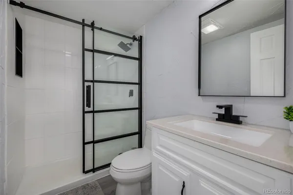 a bathroom with a sink toilet and shower