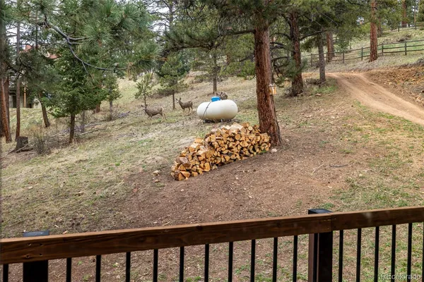 a view of a wooden bench next to a yard