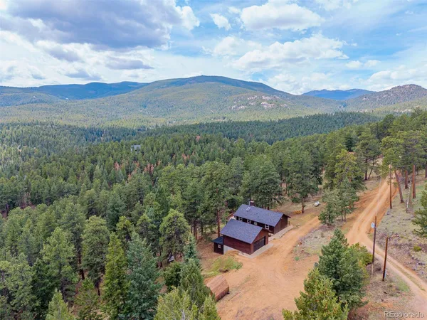 an aerial view of residential house with outdoor space and mountain view