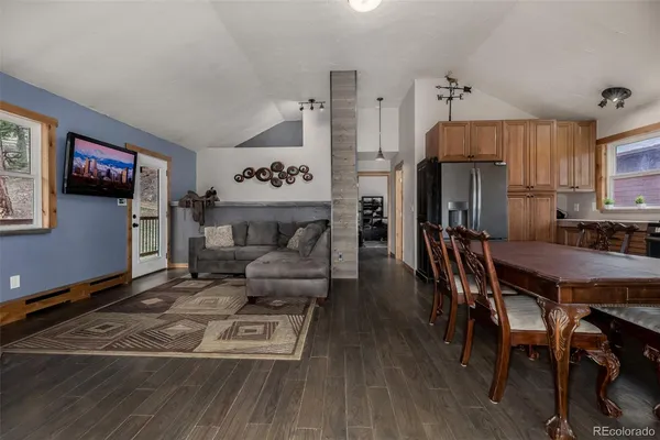 a living room with furniture a flat screen tv and a table