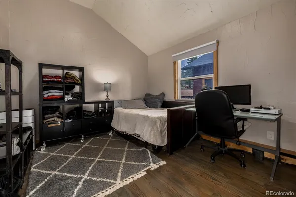 a bedroom with furniture and a window