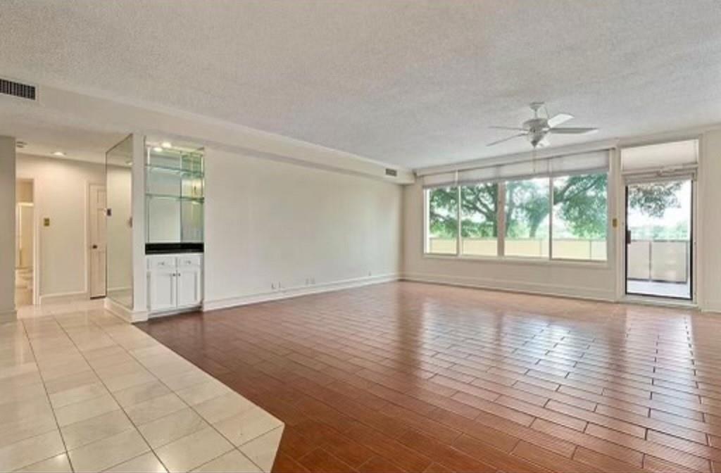 2103 Reflection Bay Drive Arlington, TX 76013 - Photo 5 of 7 a view of an empty room with wooden floor and a window