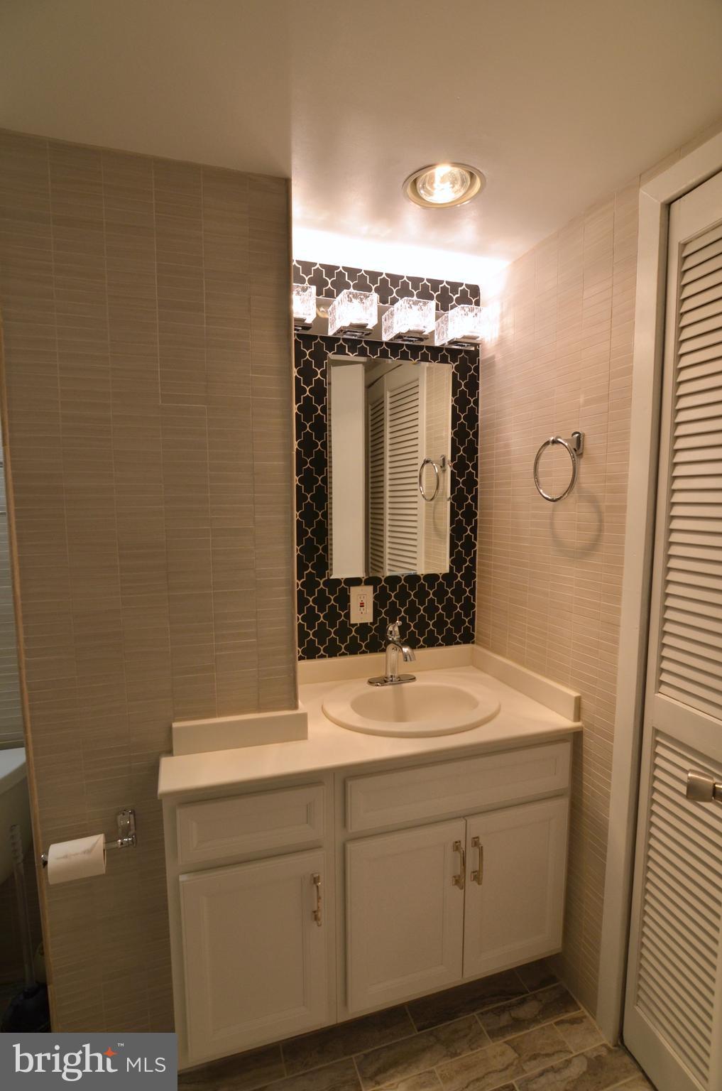 2114 N Street Northwest, Unit 2 Washington, DC 20037 - Photo 18 of 24 a bathroom with a sink and a mirror