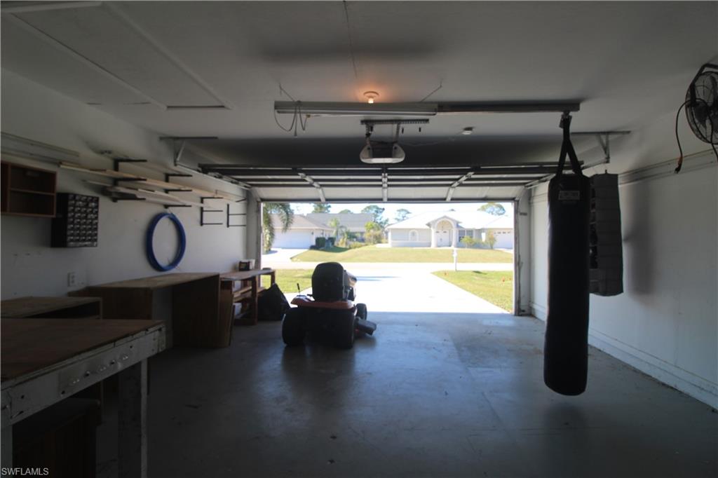 18257 Sycamore Road Fort Myers, FL 33967 - Photo 12 of 19 Garage featuring a garage door opener