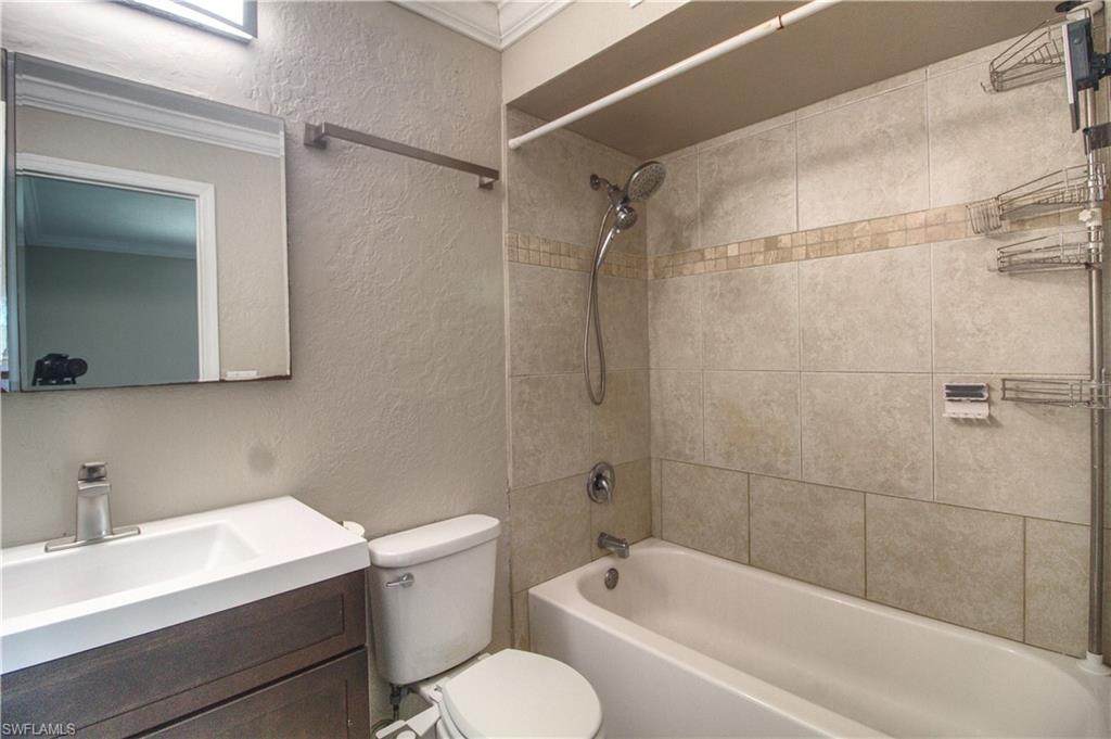 18257 Sycamore Road Fort Myers, FL 33967 - Photo 7 of 19 Master bathroom with vanity, ornamental molding, tiled shower / bath combo, and toilet