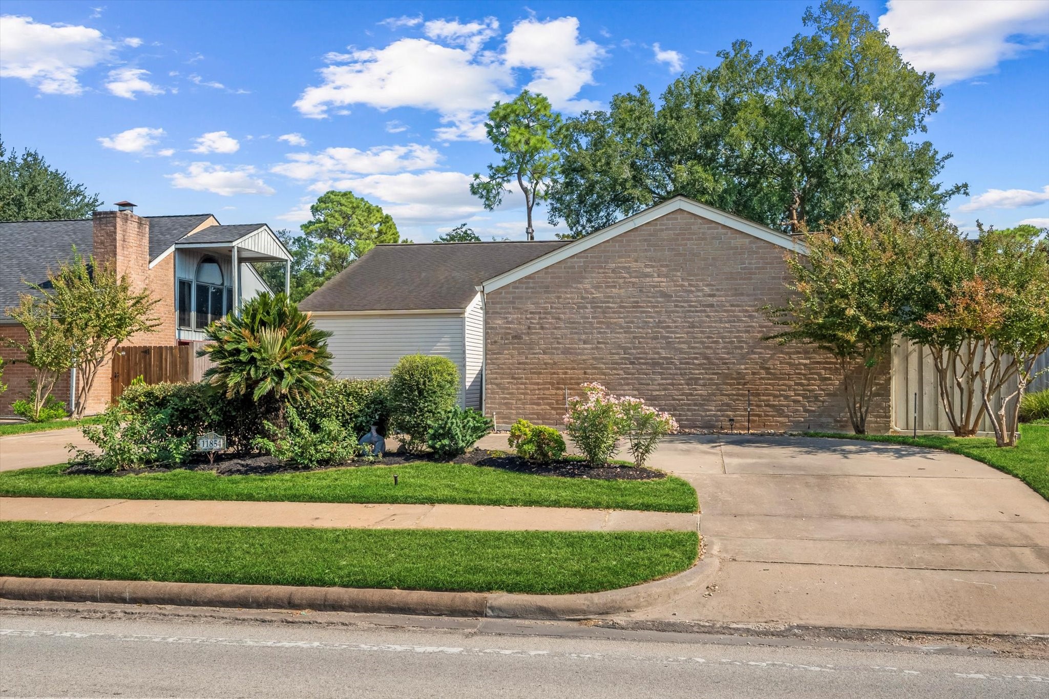 a front view of a house with a yard and potted plants