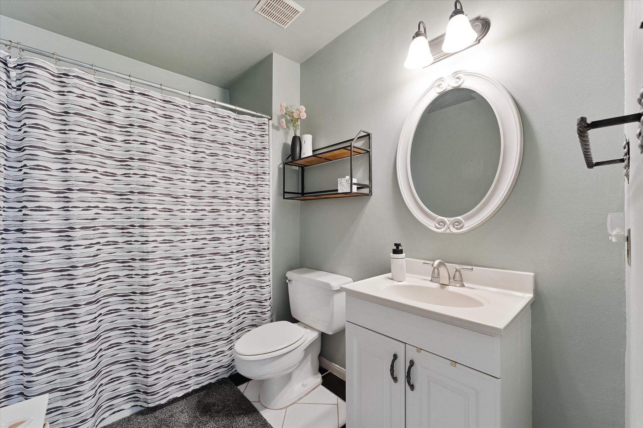 11854 Briar Forest Drive Houston, TX 77077 - Photo 14 of 21 a bathroom with a sink a toilet and a mirror